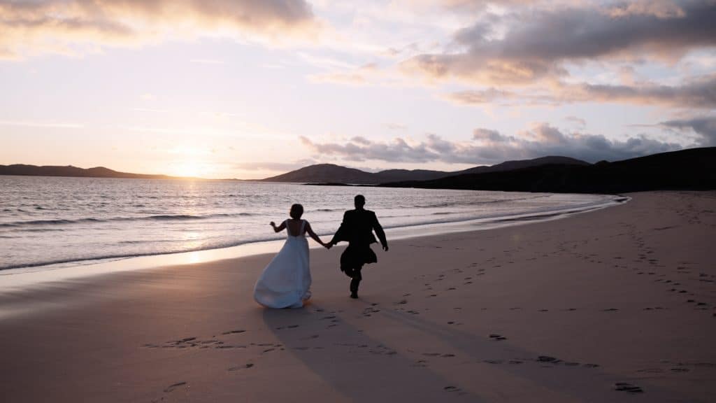 wedding couple running into sunset isle of harris
