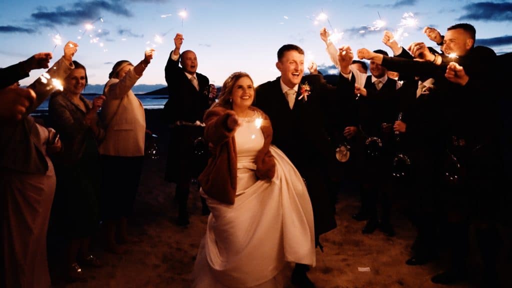 wedding couple enjoying sparklers on beach on isle of harris