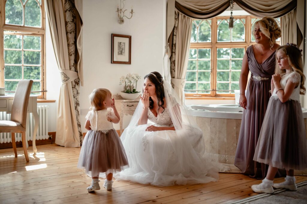 bride blowing a kiss to her baby daughter in bridal suite