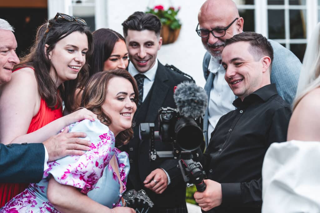 Michael Westcott Films showing wedding guests the shot on back of the camera
