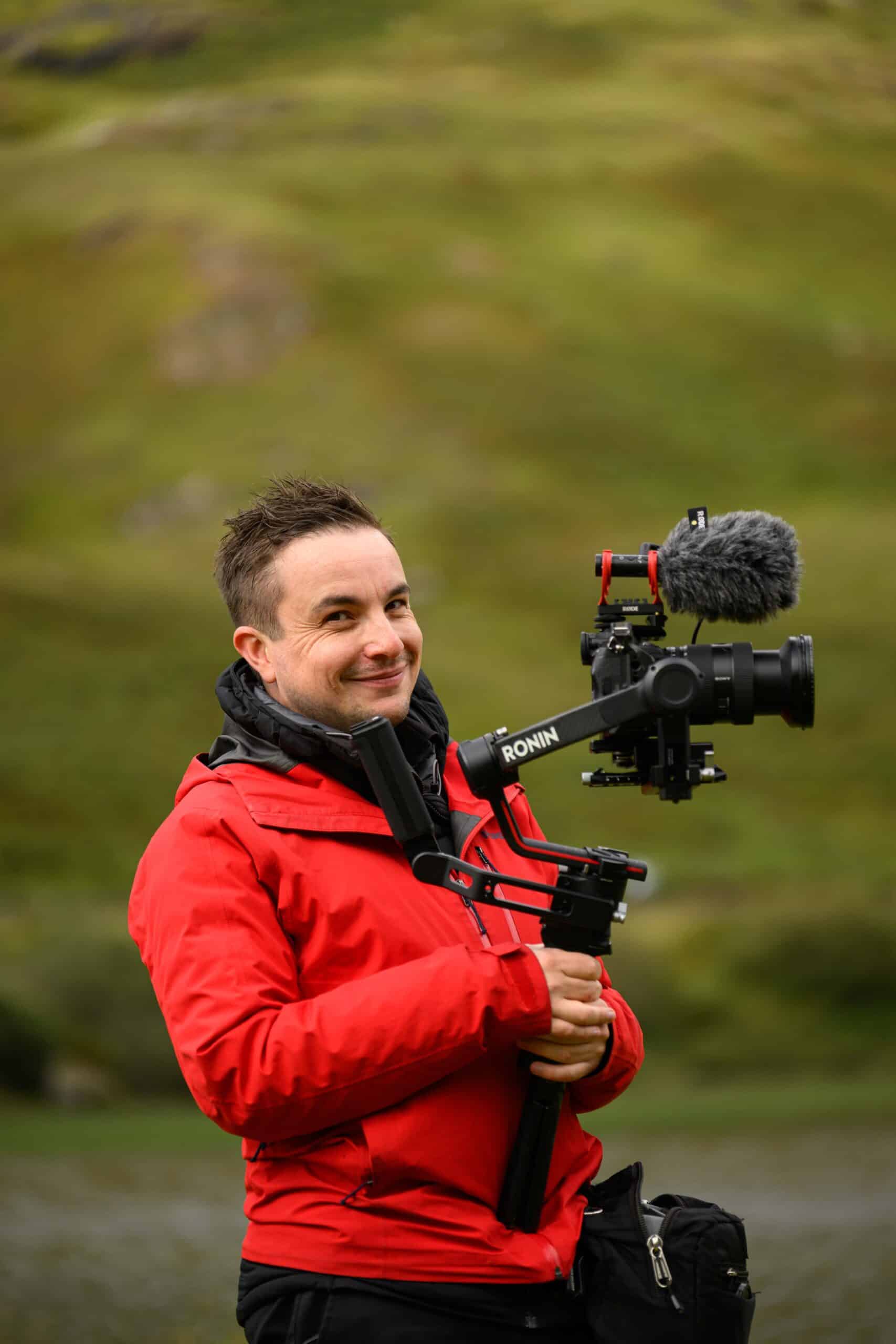 Michael Westcott Smiling at camera whilst holding a dji rs3 pro gimbal filming a ceremony in glencoe scotland